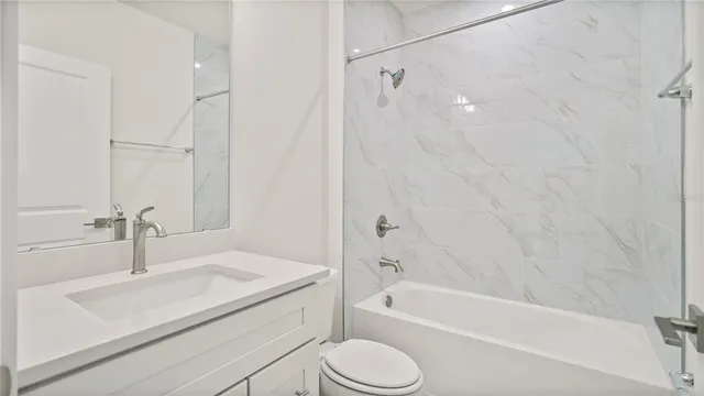 a bathroom with a sink a toilet and a bathtub