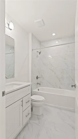 a bathroom with a toilet a sink and a bathtub
