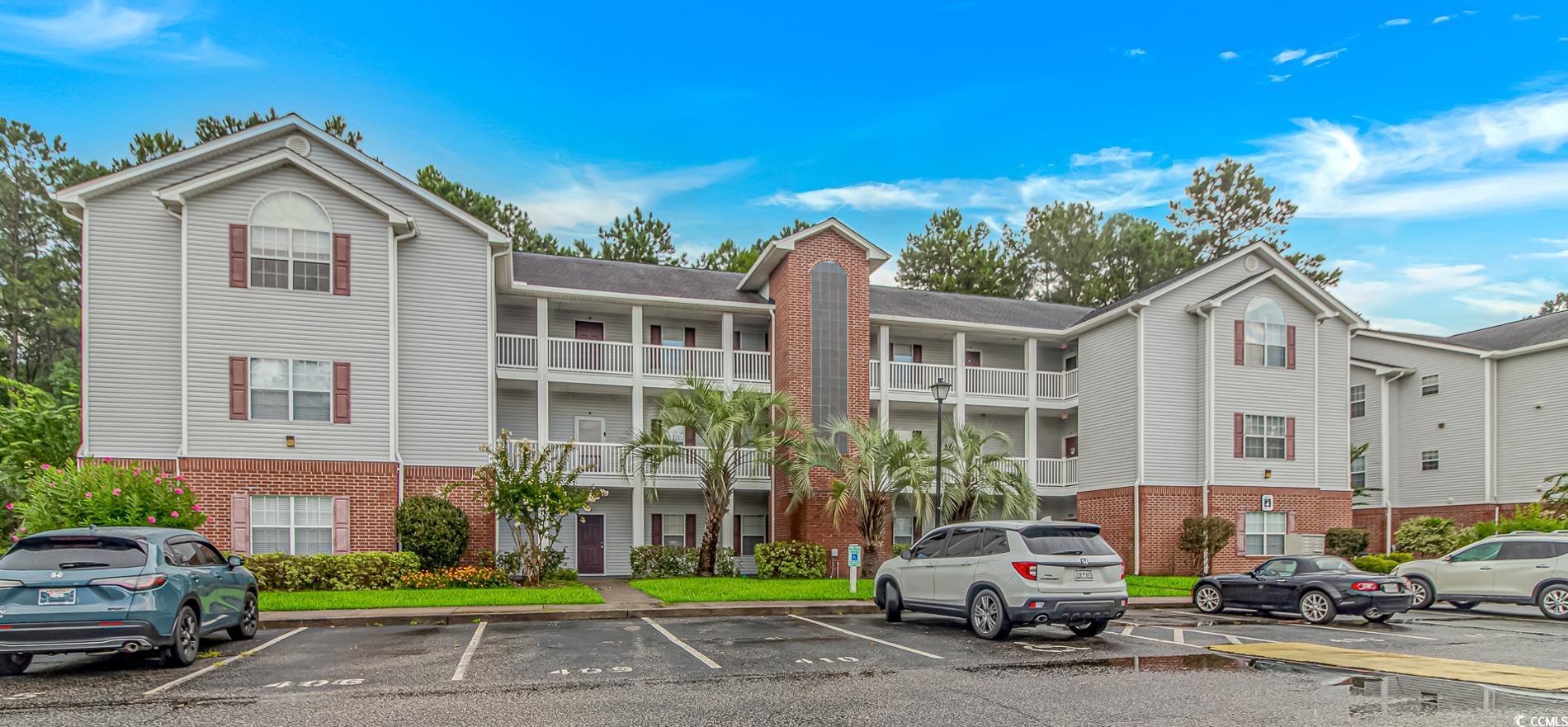 4814 Innisbrook Court, Unit 407 Myrtle Beach, SC 29579 - Photo 1 of 31 View of apartment building / complex with uncovered parking