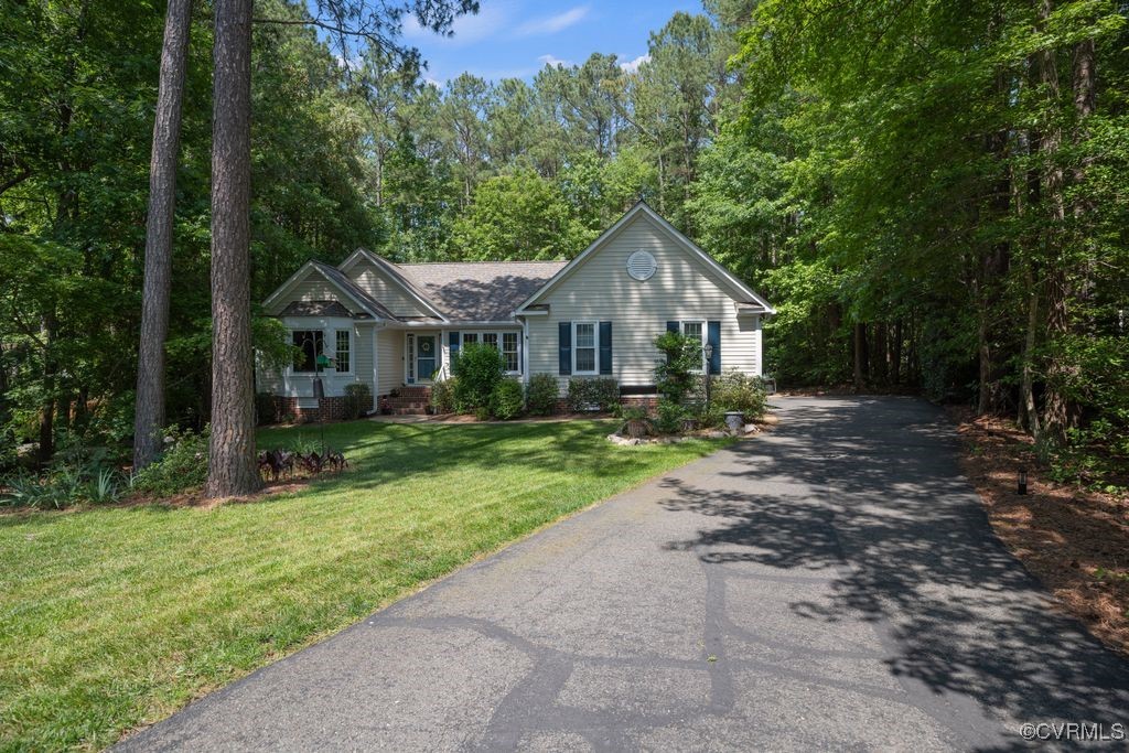 15300 Houndmaster Circle Midlothian, VA 23112 - Photo 2 of 48 a front view of a house with a yard and trees