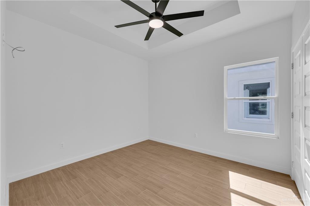 2904 Gabriel Street, Unit 4 Mission, TX 78574 - Photo 8 of 11 an empty room with a window and a fan