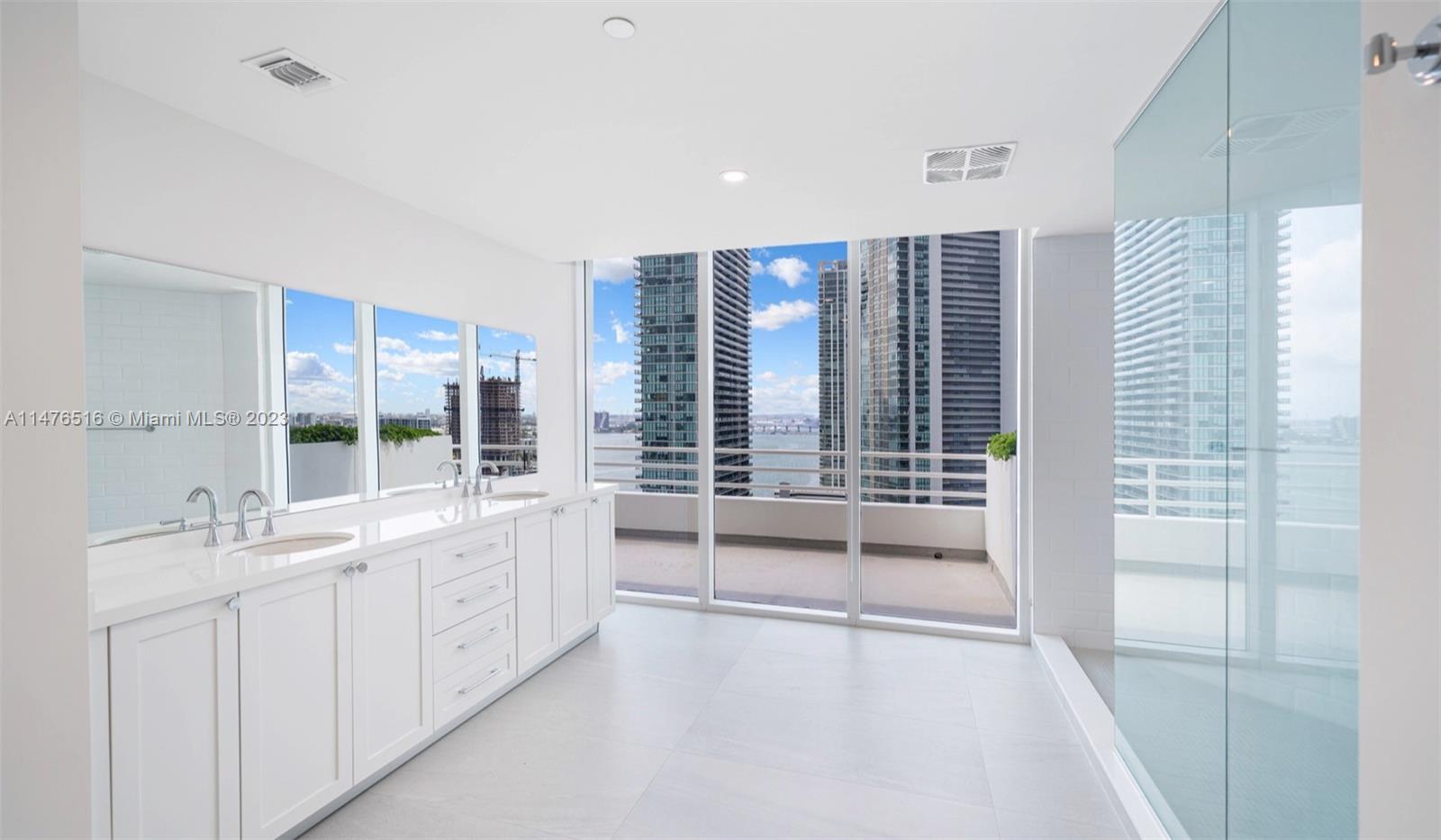 555 Northeast 34th Street, Unit PH5 Miami, FL 33137 - Photo 17 of 29 a bathroom with a double vanity sink and large window