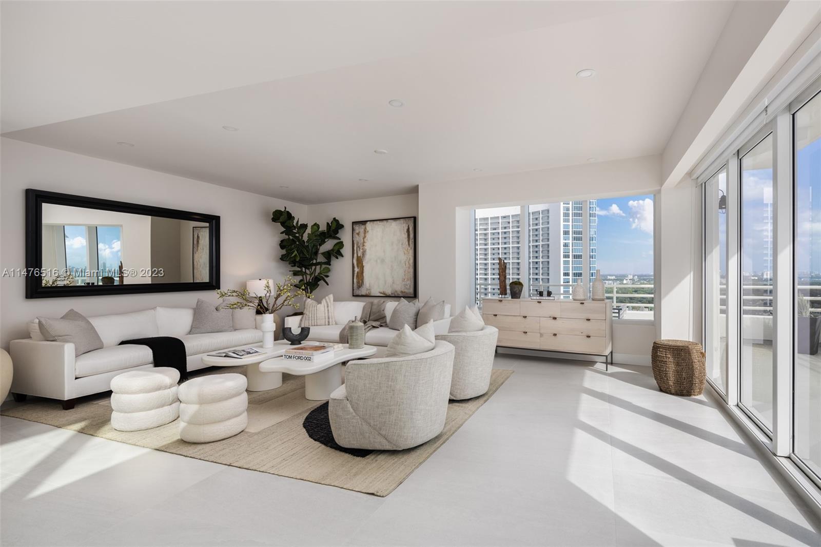 555 Northeast 34th Street, Unit PH5 Miami, FL 33137 - Photo 3 of 29 a living room with furniture and a flat screen tv