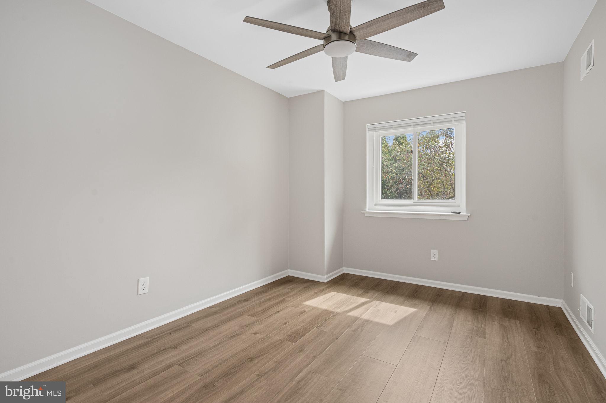 113 Talgrath Court Exton, PA 19341 - Photo 17 of 25 an empty room with wooden floor ceiling fan and windows
