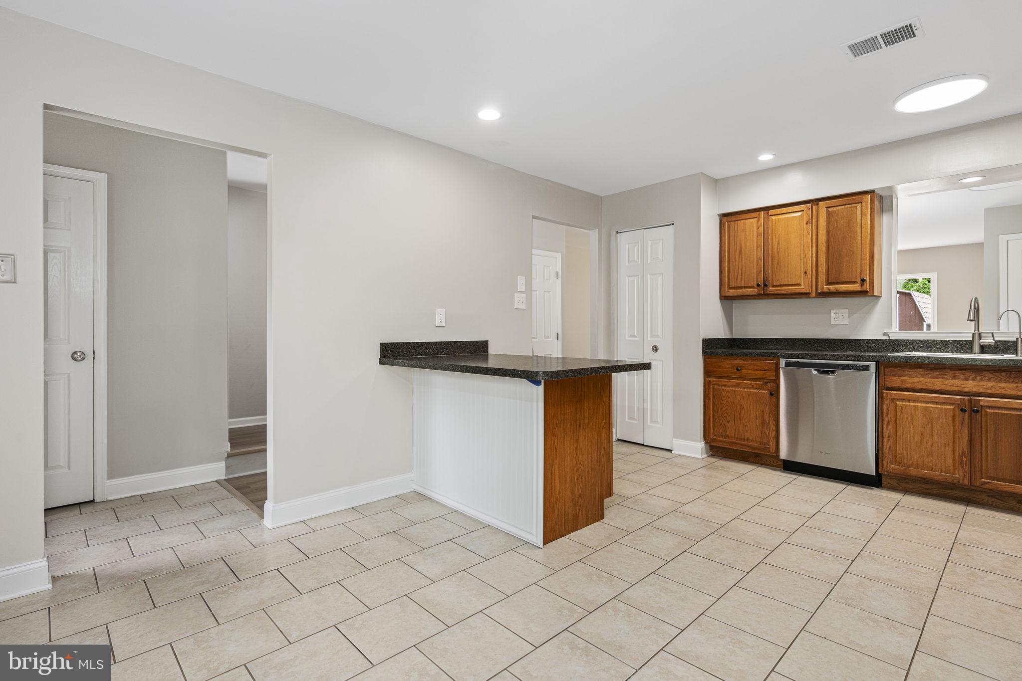 113 Talgrath Court Exton, PA 19341 - Photo 6 of 25 a kitchen with stainless steel appliances granite countertop a sink stove and cabinets