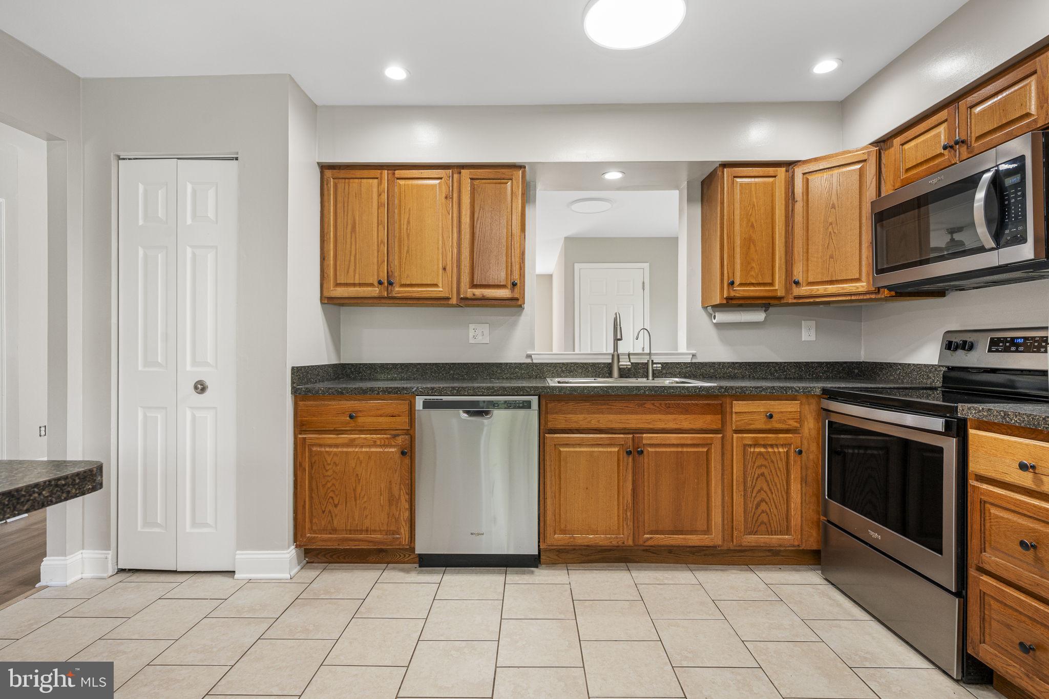113 Talgrath Court Exton, PA 19341 - Photo 8 of 25 a kitchen with stainless steel appliances granite countertop a stove a sink and a microwave