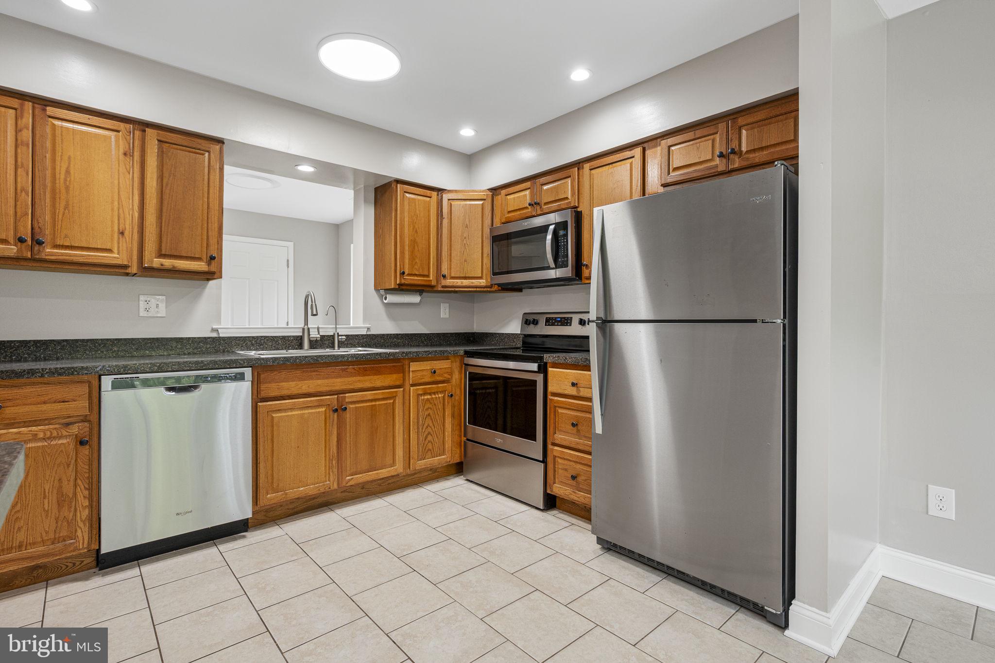 113 Talgrath Court Exton, PA 19341 - Photo 9 of 25 a kitchen with a refrigerator sink and cabinets