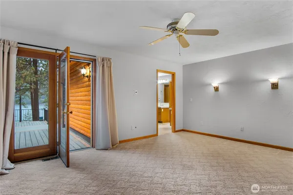 a view of a livingroom with a ceiling fan and window
