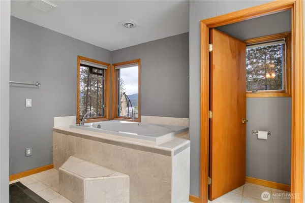a room with a sink and large mirror