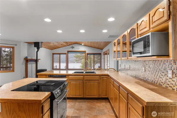 a kitchen with stainless steel appliances granite countertop a sink and a stove