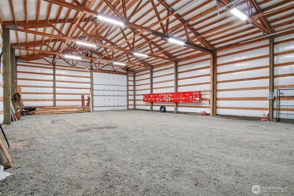 a view of a garage with furniture and white walls