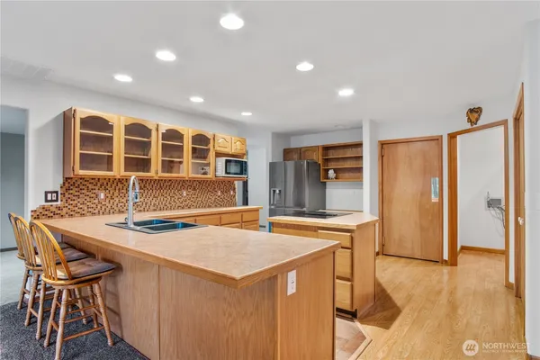 a kitchen that has a table and chairs in it