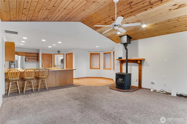 a view of kitchen with furniture and refrigerator