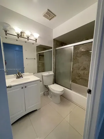 a bathroom with a toilet sink and shower