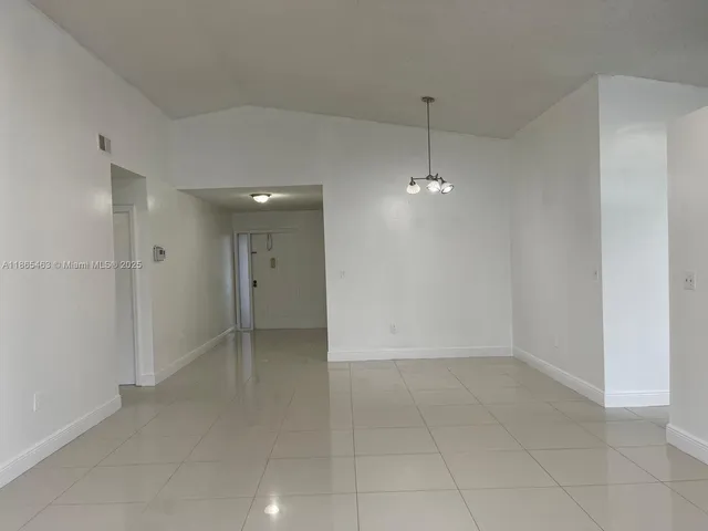 a view of an empty room with glass door