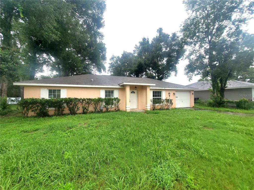 13589 Southwest 107th Place Dunnellon, FL 34432 - Photo 1 of 8 a front of a house with a garden and yard