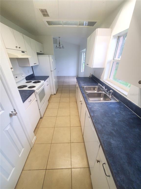13589 Southwest 107th Place Dunnellon, FL 34432 - Photo 4 of 8 a kitchen with stainless steel appliances granite countertop a sink and a stove