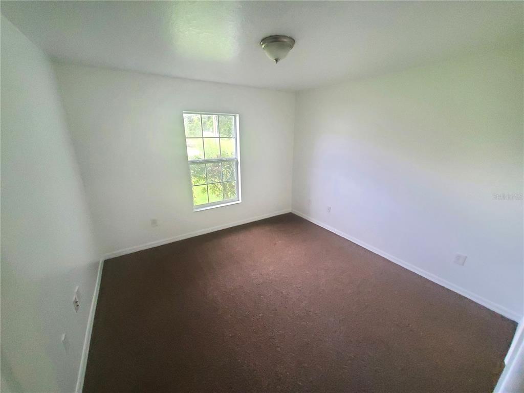 13589 Southwest 107th Place Dunnellon, FL 34432 - Photo 6 of 8 an empty room with a window