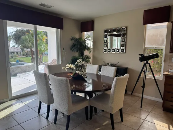 a kitchen with a dining table chairs and view kitchen