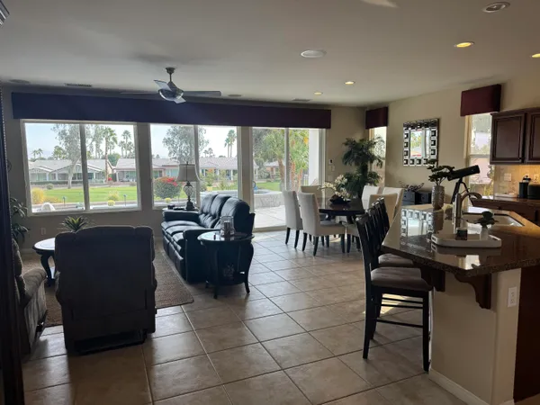 a living room with furniture kitchen and a table