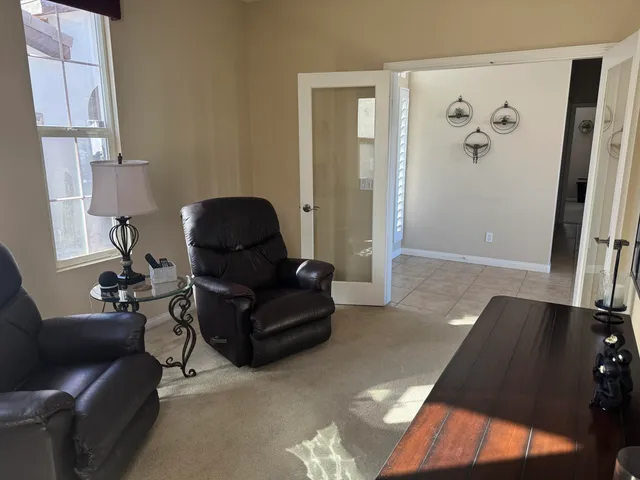 a backyard of a house with table and chairs