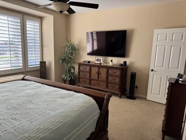 a bed sitting in a bedroom next to a window