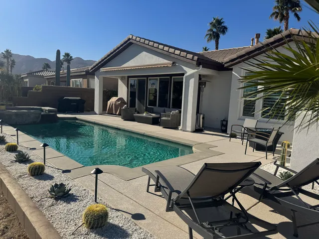 a view of a backyard with sitting area