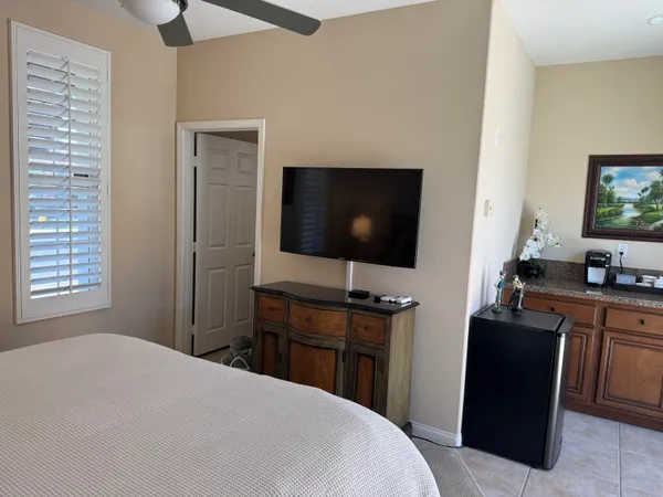 a large bed sitting in a bedroom next to a lamp