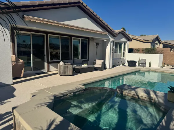 a swimming pool with patio outdoor seating and yard
