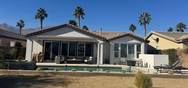 a living room with furniture kitchen and a table