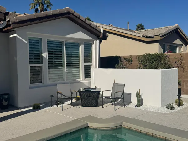 a terrace of a house with outdoor seating