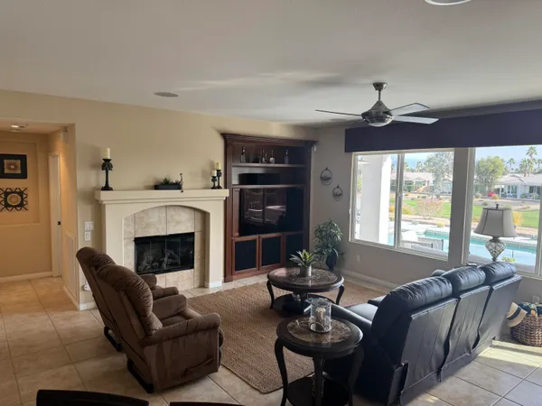a living room with furniture a fireplace and a flat screen tv