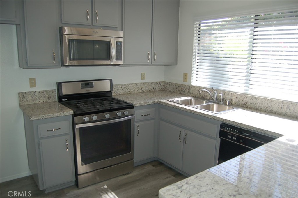 47 Deer Creek Road Phillips Ranch, CA 91766 - Photo 11 of 24 a kitchen with granite countertop cabinets stainless steel appliances a sink and a window