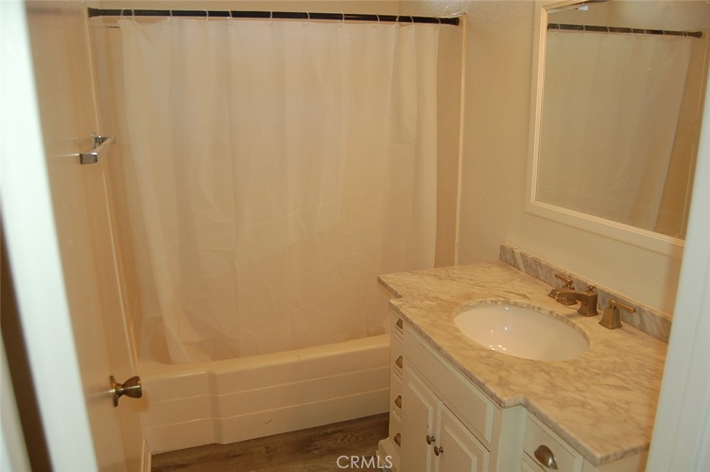47 Deer Creek Road Phillips Ranch, CA 91766 - Photo 13 of 24 a bathroom with a granite countertop sink and a mirror