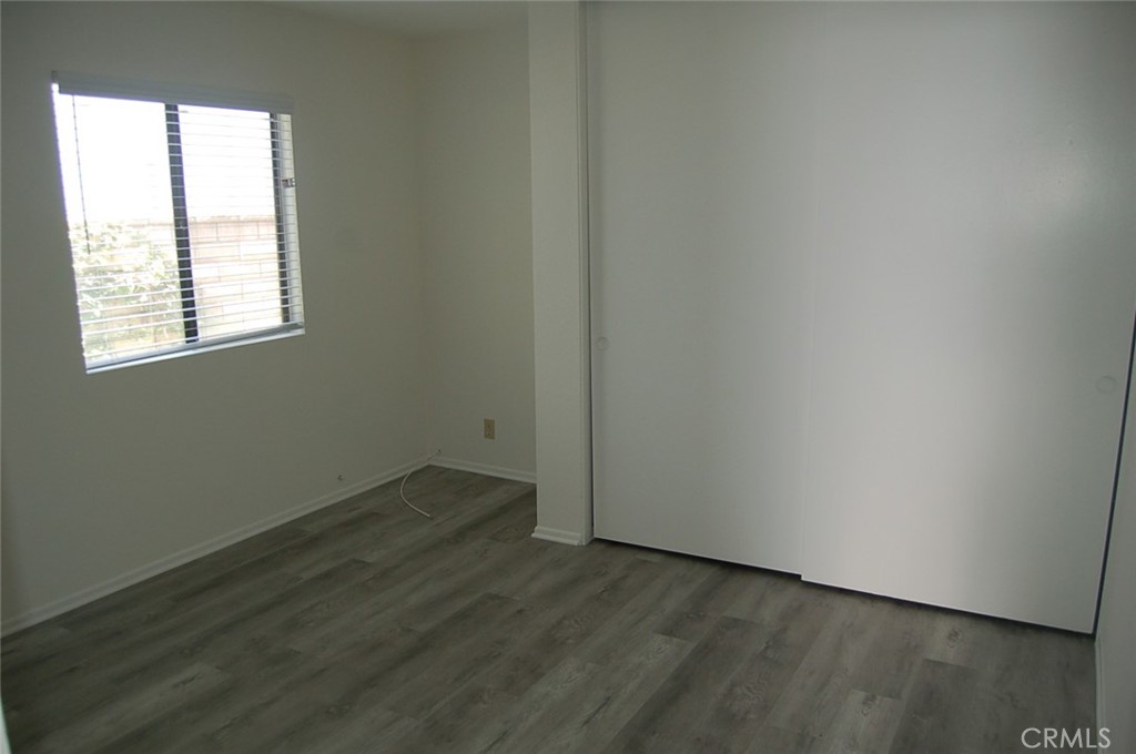 47 Deer Creek Road Phillips Ranch, CA 91766 - Photo 14 of 24 an empty room with wooden floor and windows