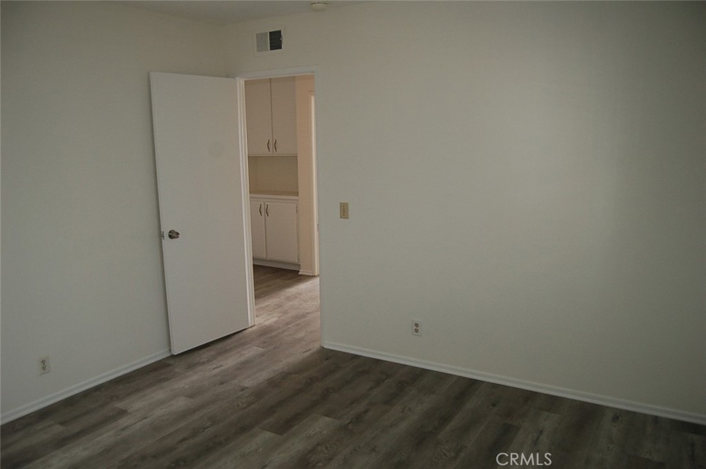 47 Deer Creek Road Phillips Ranch, CA 91766 - Photo 15 of 24 an empty room with wooden floor and windows