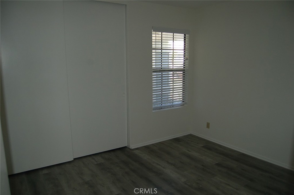 47 Deer Creek Road Phillips Ranch, CA 91766 - Photo 19 of 24 a view of an empty room with wooden floor and a window