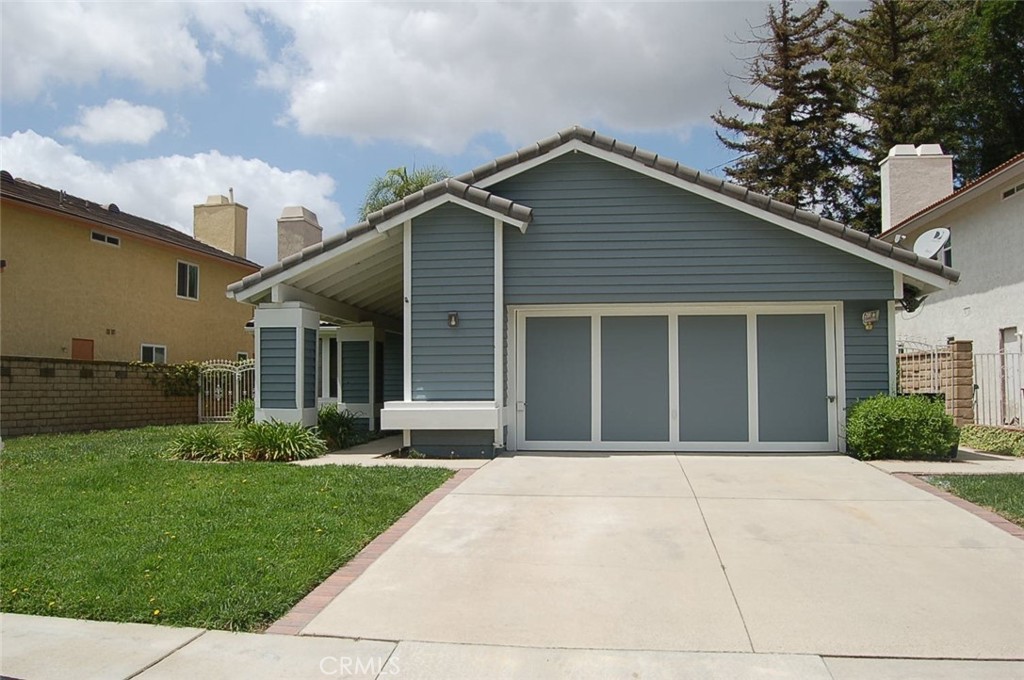 47 Deer Creek Road Phillips Ranch, CA 91766 - Photo 2 of 24 a front view of a house with a garden and yard