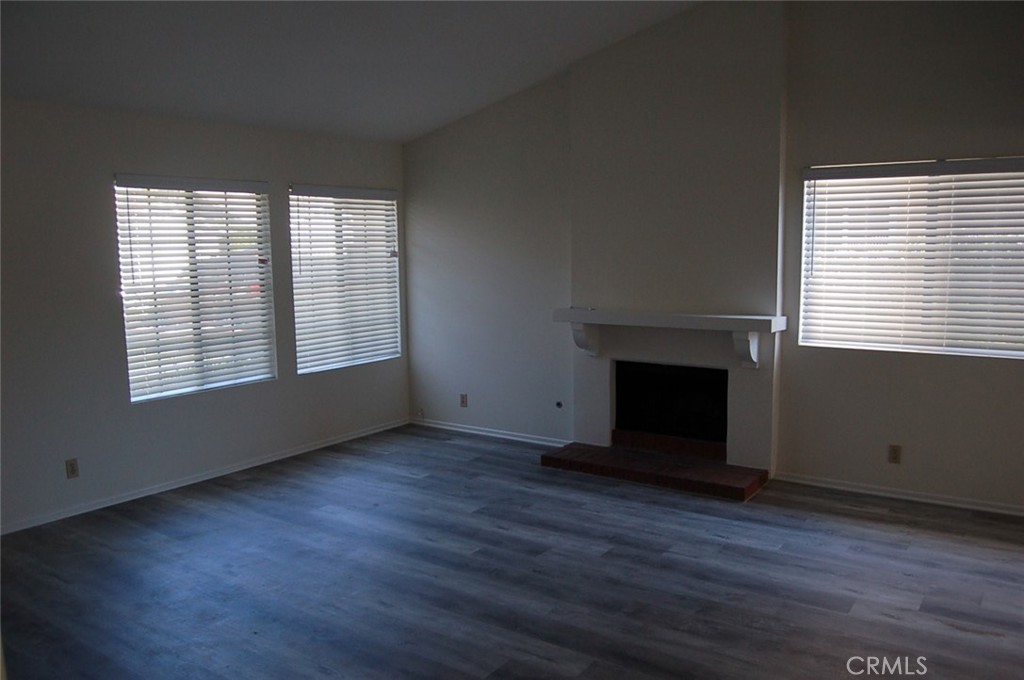 47 Deer Creek Road Phillips Ranch, CA 91766 - Photo 4 of 24 an empty room with wooden floor and windows