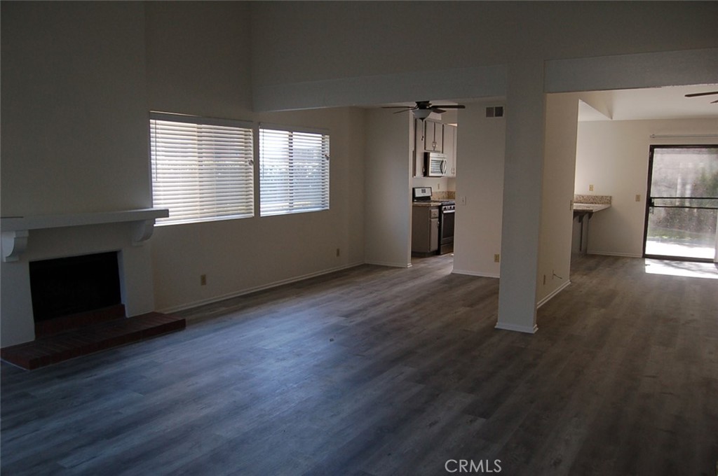 47 Deer Creek Road Phillips Ranch, CA 91766 - Photo 5 of 24 an empty room with wooden floor and windows