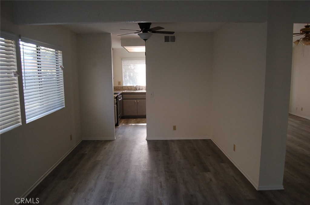 47 Deer Creek Road Phillips Ranch, CA 91766 - Photo 7 of 24 an empty room with wooden floor and windows