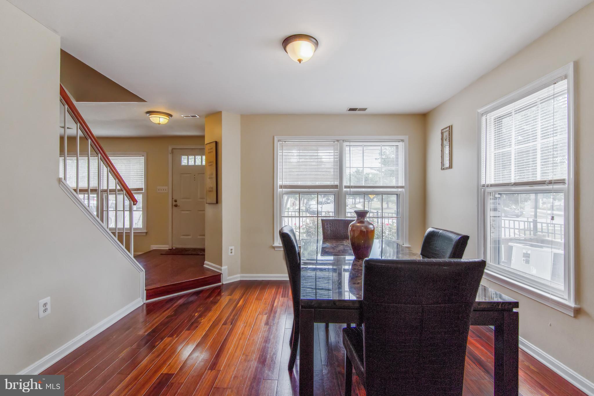 9304 Palmer Place, Unit 5 Laurel, MD 20708 - Photo 10 of 30 a view of a dining room with furniture window and wooden floor