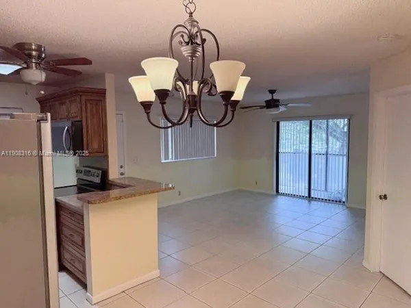 a view of a kitchen with a sink and chandelier