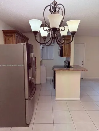 a kitchen with stainless steel appliances granite countertop a sink a stove and a microwave