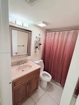a bathroom with a sink a toilet a mirror and vanity