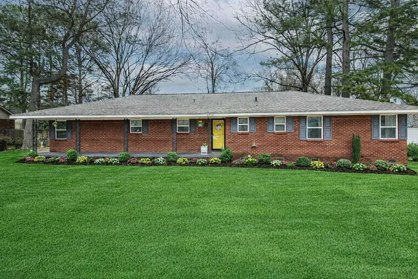 a front view of house with yard and green space