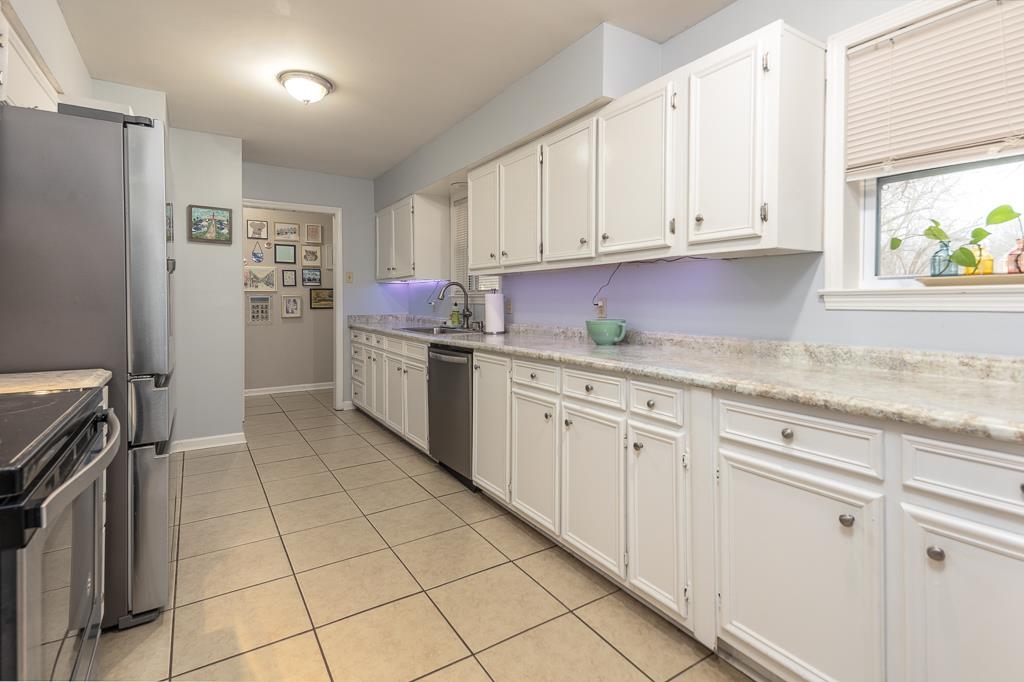 2662 Elmore Park Road Bartlett, TN 38134 - Photo 13 of 28 a kitchen with stainless steel appliances granite countertop a refrigerator sink and cabinets