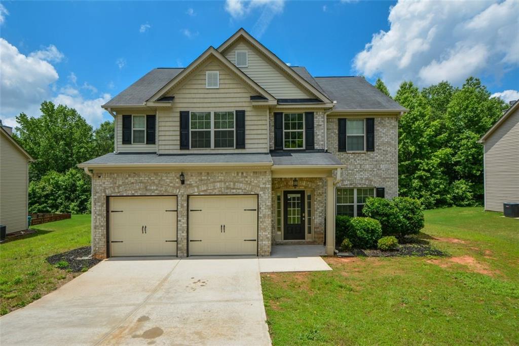 917 Revere Way Hampton, GA 30228 - Photo 1 of 25 a front view of a house with a garden and plants