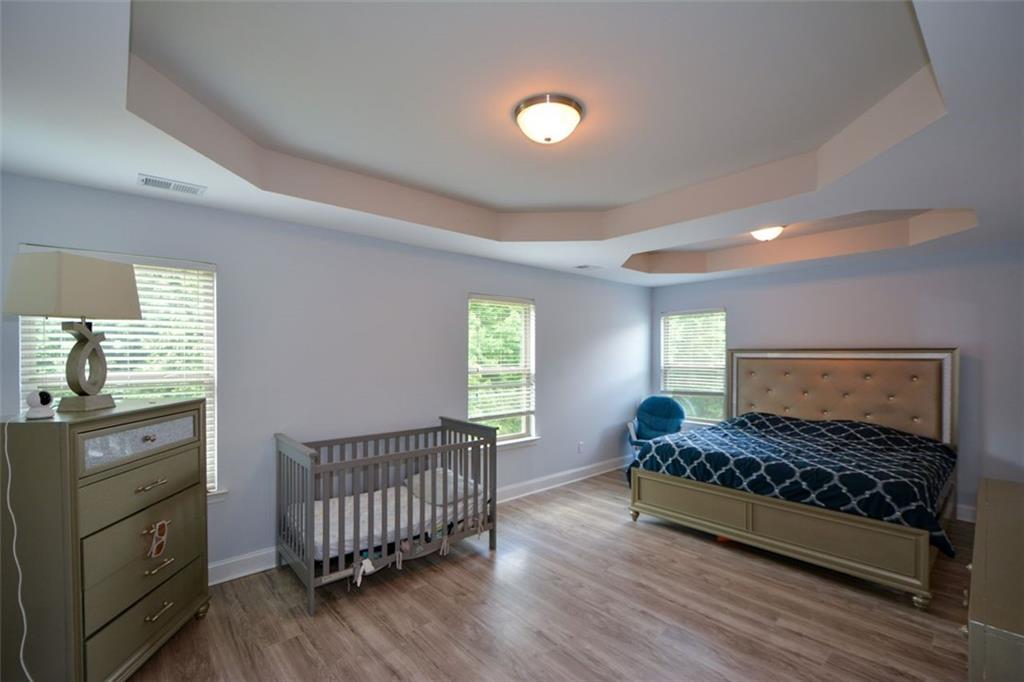 917 Revere Way Hampton, GA 30228 - Photo 14 of 25 a spacious bedroom with a bed and a window