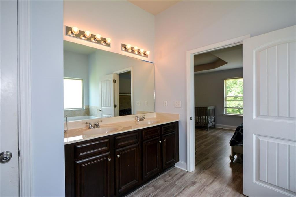 917 Revere Way Hampton, GA 30228 - Photo 17 of 25 a bathroom with a double vanity sink and a mirror